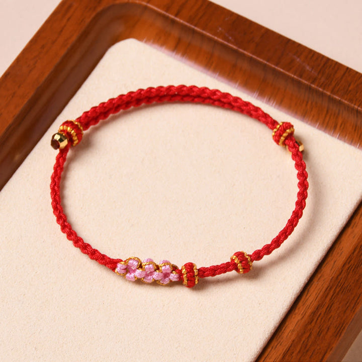 Braccialetto di corda intrecciata con protezione in fiore di pesco fatto a mano Buddha Stones