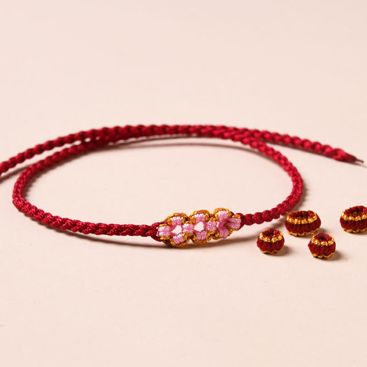 Braccialetto di corda intrecciata con protezione in fiore di pesco fatto a mano Buddha Stones