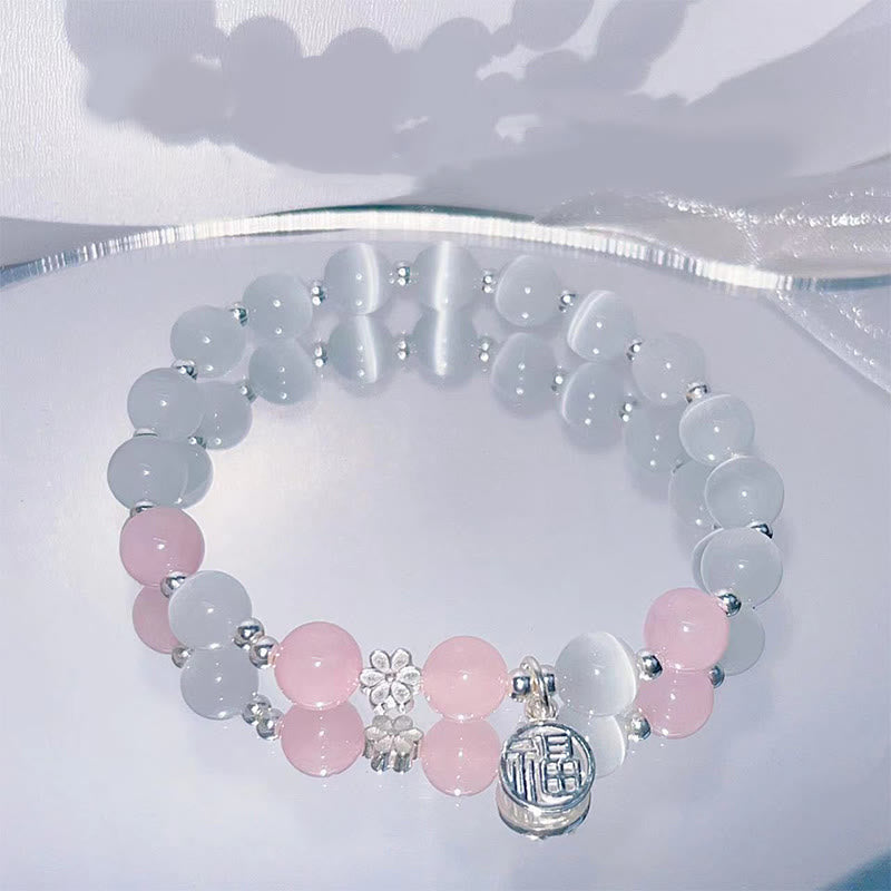 Braccialetto di supporto con ciondolo a forma di carattere Fu con campanella in fiore di pesco e cristalli occhio di gatto Buddha Stones
