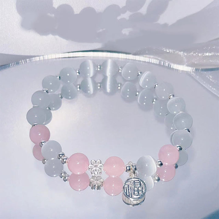 Braccialetto di supporto con ciondolo a forma di carattere Fu con campanella in fiore di pesco e cristalli occhio di gatto Buddha Stones