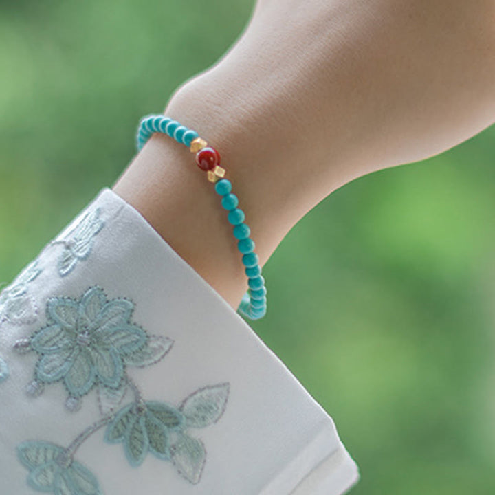 Braccialetto di protezione con perline di agata rossa e turchese Buddha Stones