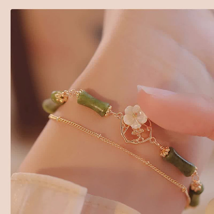 Bracciale Buddha Stones in rame placcato oro 14k con fiore di bambù, peridoto e doppio strato di ricchezza