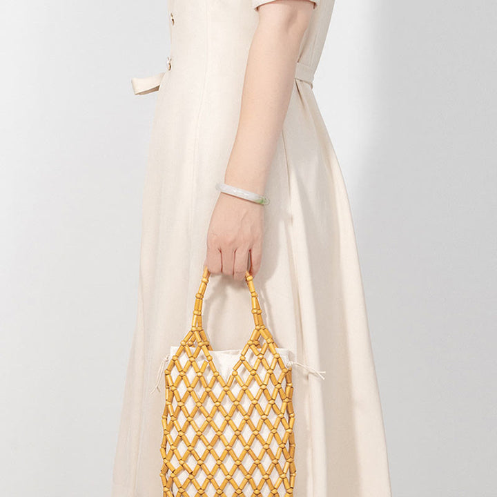 Borsa a mano con perline di legno cave intrecciate a mano in Buddha Stones