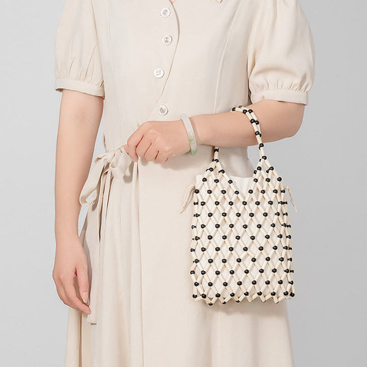 Borsa a mano con perline di legno cave intrecciate a mano in Buddha Stones