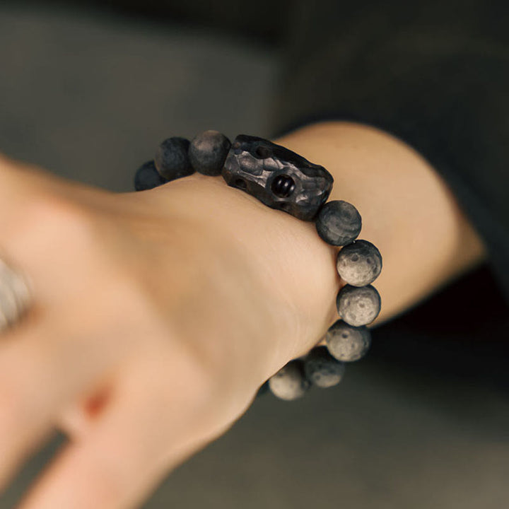 Braccialetto rilassante in legno di ebano e ossidiana con Buddha Stones in argento lucido