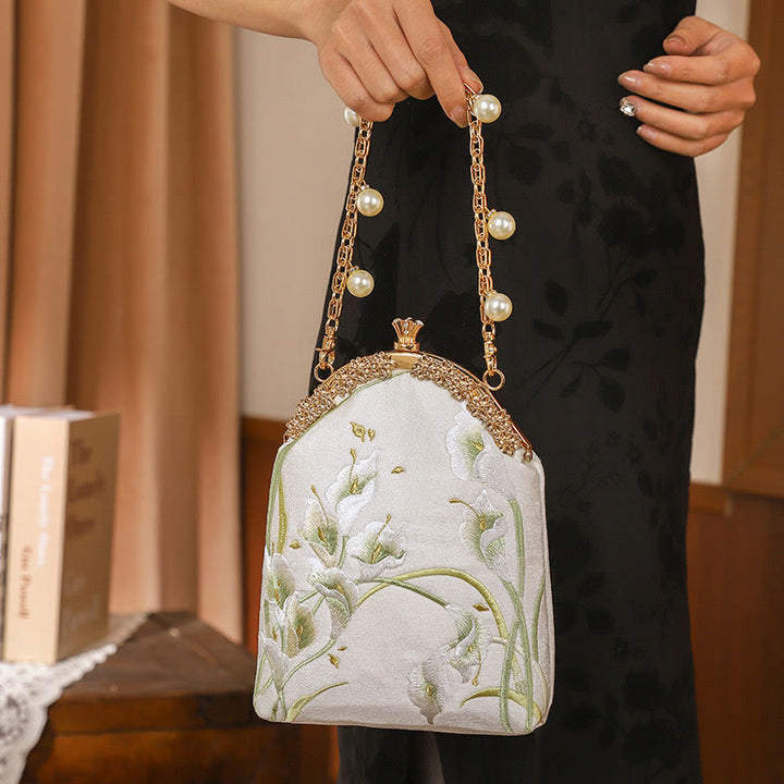 Borsa a tracolla con manico in metallo e ricamo Calla Buddha Stones