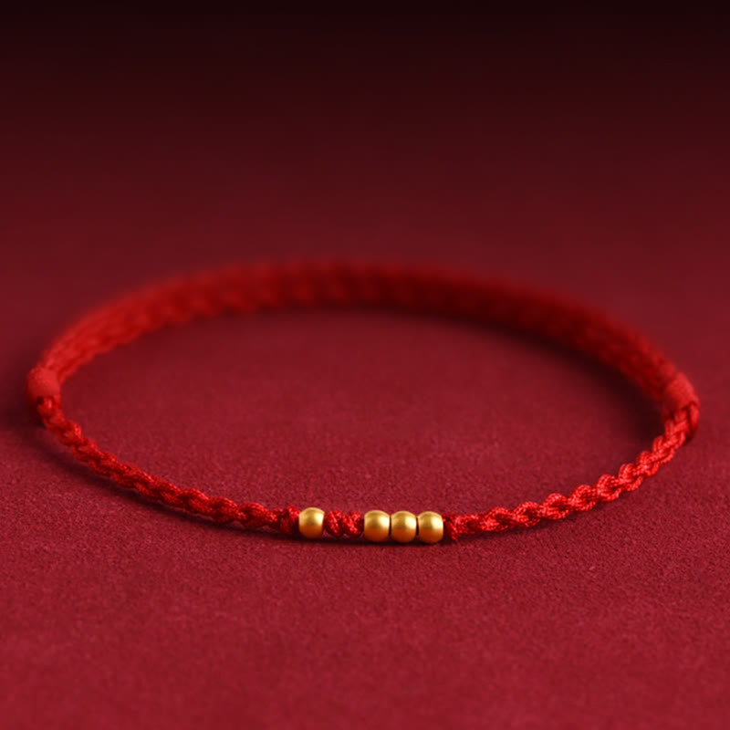 Braccialetto di coppia con protezione intrecciata in perline d'oro 999 Buddha Stones - Corda rossa (una e tre perle dorate) - 24 centimetri - image 0
