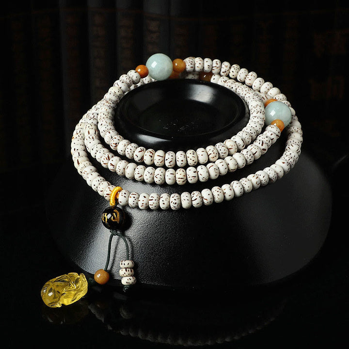Braccialetto della ricchezza in agata ambrata con semi di Bodhi tibetano e pietre Buddha Stones