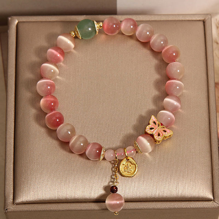 Braccialetto della pace con farfalla occhio di gatto rosa sfumato Buddha Stones