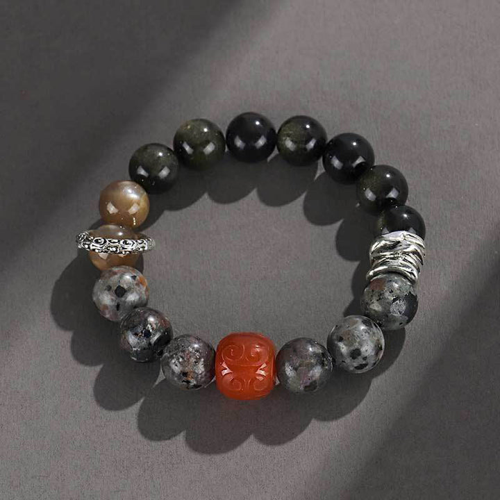 Braccialetto di protezione in agata rossa, ossidiana, pietra lavica e pietre dorate Buddha Stones