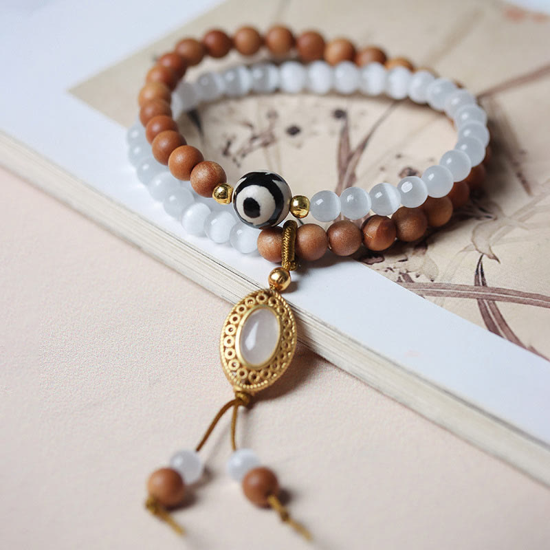 Braccialetto di protezione in cristallo con perline Dzi a tre occhi, occhio di gatto, Buddha Stones sandalo
