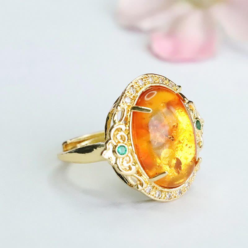 Anello di messa a fuoco con uovo di piccione, fiore d'ambra Buddha Stones