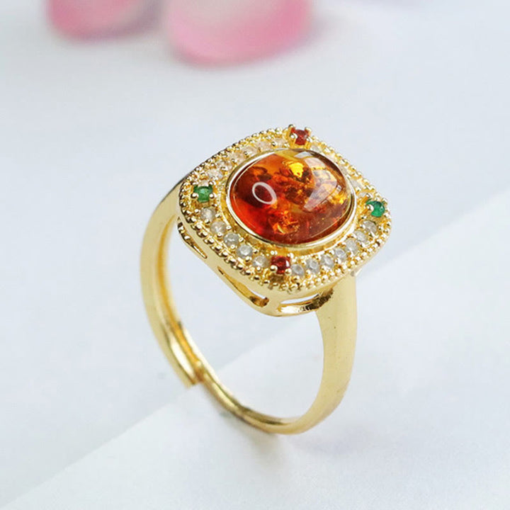 Anello di fiducia con supporto quadrato con fiore di ambra naturale Buddha Stones