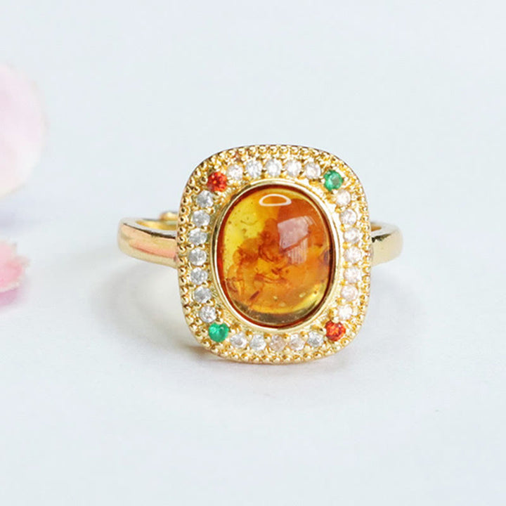 Anello di fiducia con supporto quadrato con fiore di ambra naturale Buddha Stones