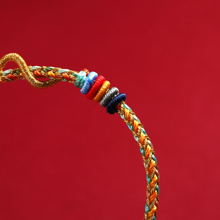 Braccialetto intrecciato di protezione dell'anno del serpente con corda rossa Buddha Stones