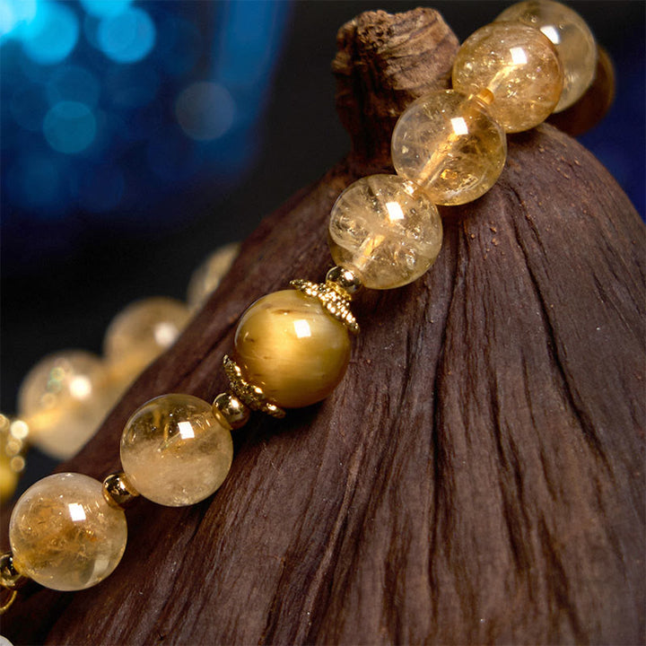 Braccialetto di generosità con ciondolo a forma di fiore con occhio di tigre e citrino Buddha Stones