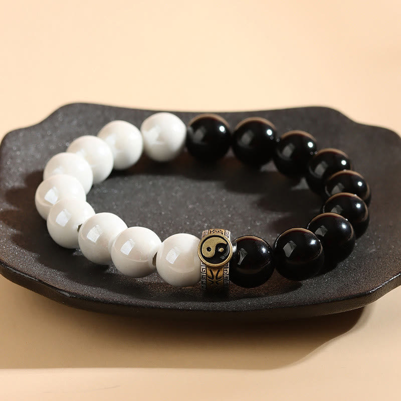 Braccialetto di realizzazione Yin Yang con perline di porcellana bianca e ossidiana nera Buddha Stones