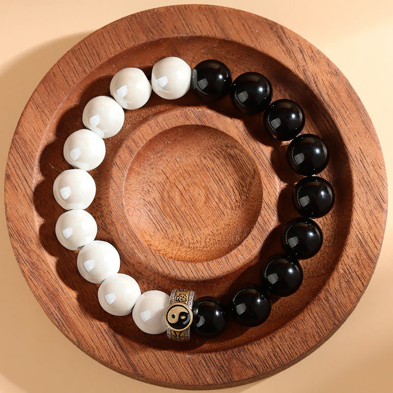 Braccialetto di realizzazione Yin Yang con perline di porcellana bianca e ossidiana nera Buddha Stones