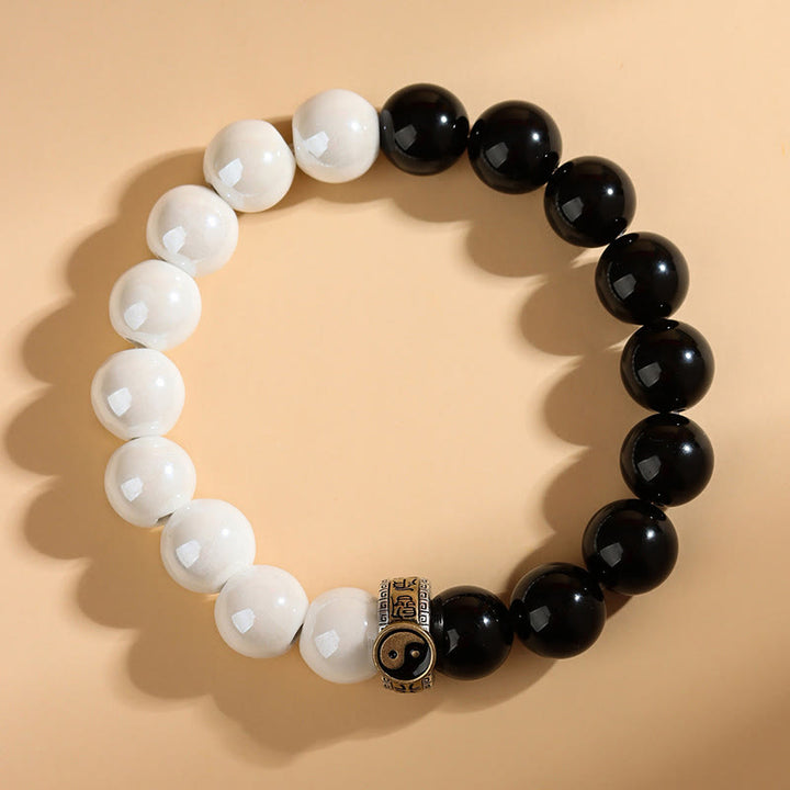Braccialetto di realizzazione Yin Yang con perline di porcellana bianca e ossidiana nera Buddha Stones