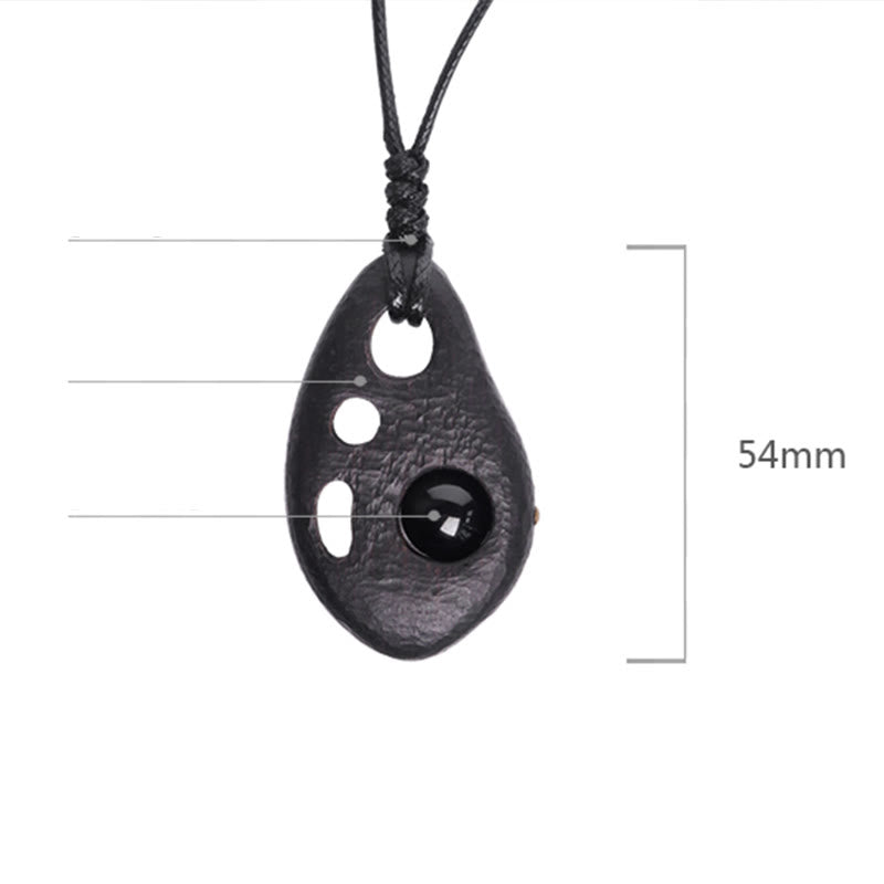 Collana con ciondolo in ossidiana intarsiata cava in legno di ebano Buddha Stones, pace e calma