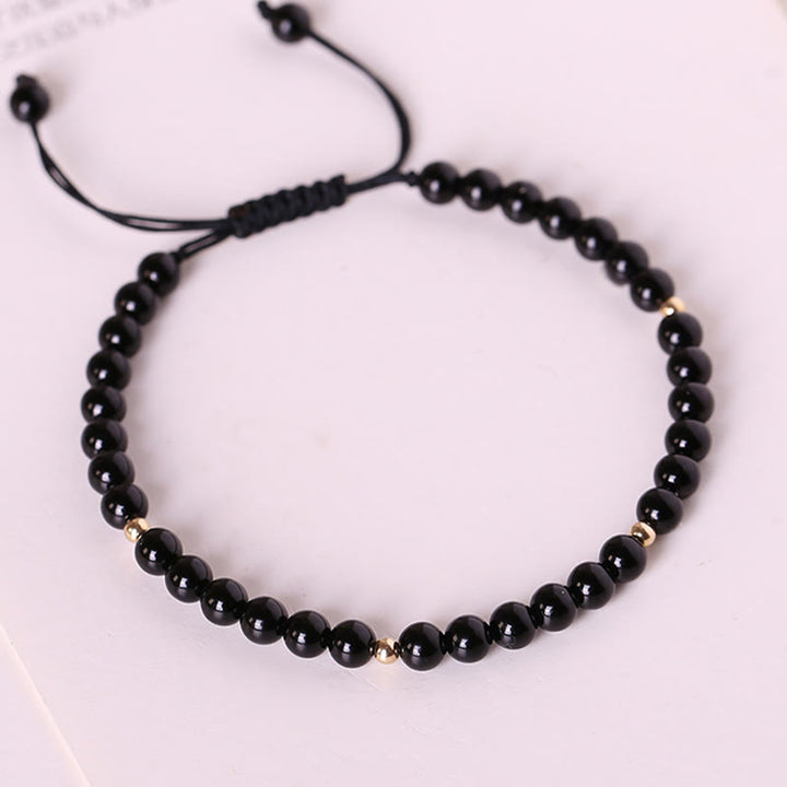 Braccialetto di corda di realizzazione con piccole perle di ossidiana nera Buddha Stones