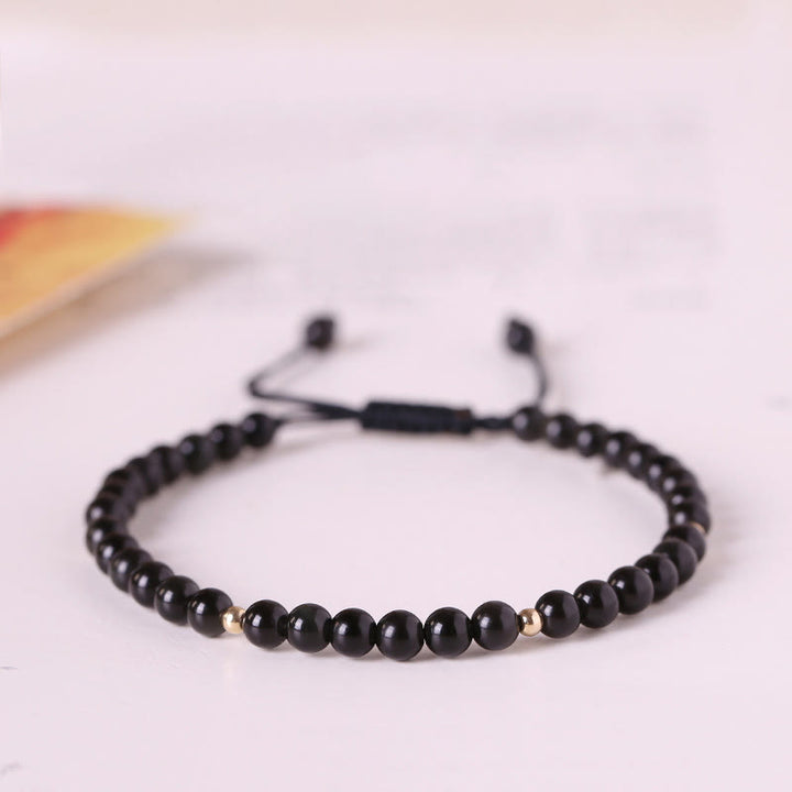 Braccialetto di corda di realizzazione con piccole perle di ossidiana nera Buddha Stones