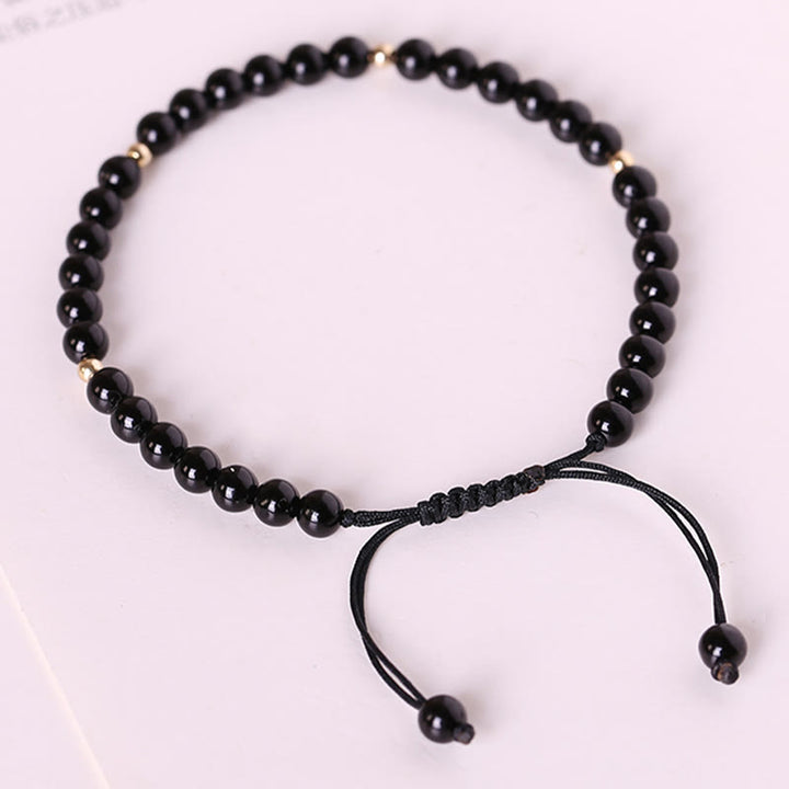 Braccialetto di corda di realizzazione con piccole perle di ossidiana nera Buddha Stones
