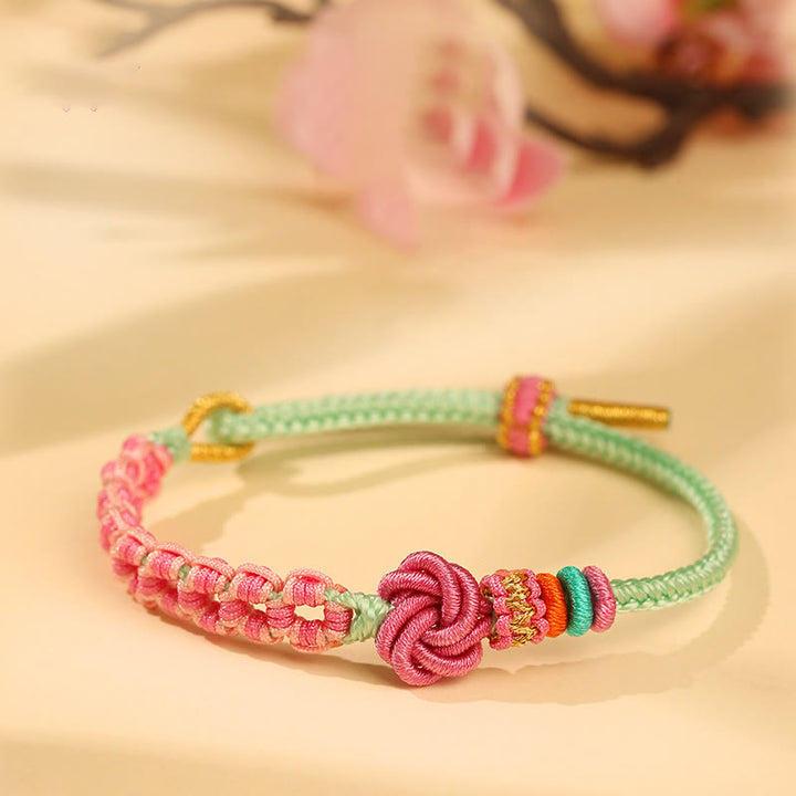 Bracciale intrecciato con nodo in fiore di pesco rosa e verde fatto a mano Buddha Stones