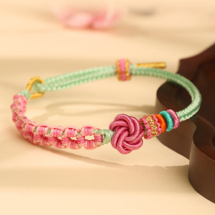 Bracciale intrecciato con nodo in fiore di pesco rosa e verde fatto a mano Buddha Stones