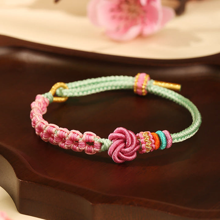Bracciale intrecciato con nodo in fiore di pesco rosa e verde fatto a mano Buddha Stones