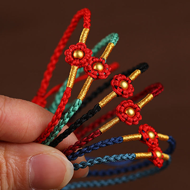 Braccialetto di corda di protezione della fortuna con design a fiori fatto a mano con perline in oro 999 Buddha Stones