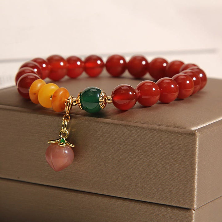 Braccialetto di autoaccettazione con ciondolo in agata rossa, ambra e pesca Buddha Stones - image 2