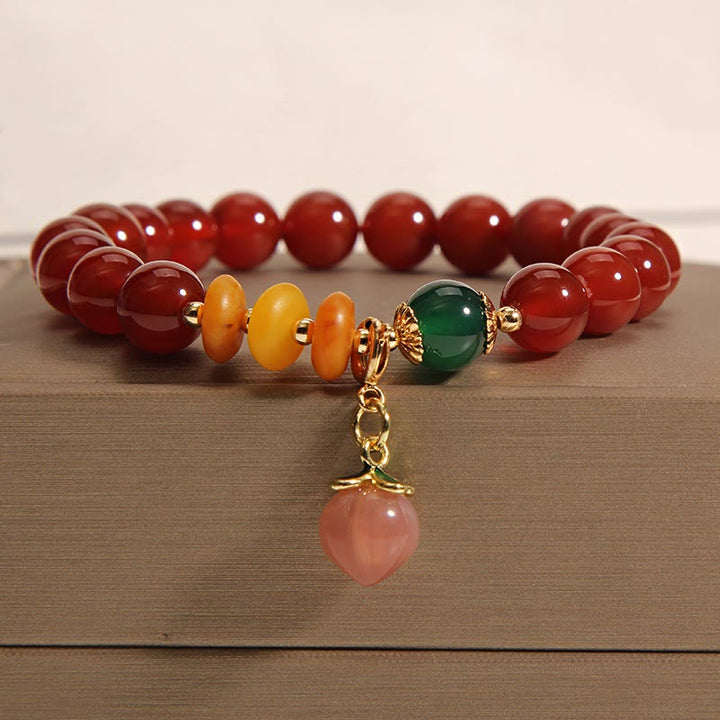 Braccialetto di autoaccettazione con ciondolo in agata rossa, ambra e pesca Buddha Stones - image 1