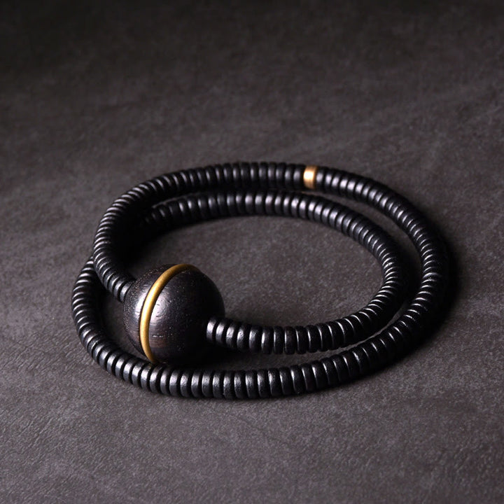 Collana con bracciale a doppio giro in Buddha Stones, in legno di ebano, in ottone e rame, con sfera di equilibrio cubica