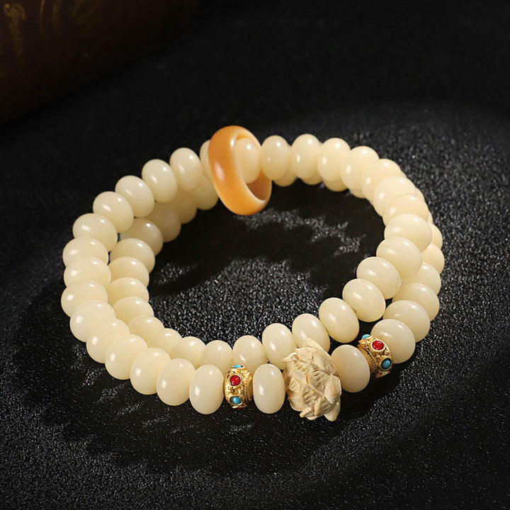Braccialetto doppio giro Buddha Stones Bodhi Seed Peach Wood Lotus Wealth
