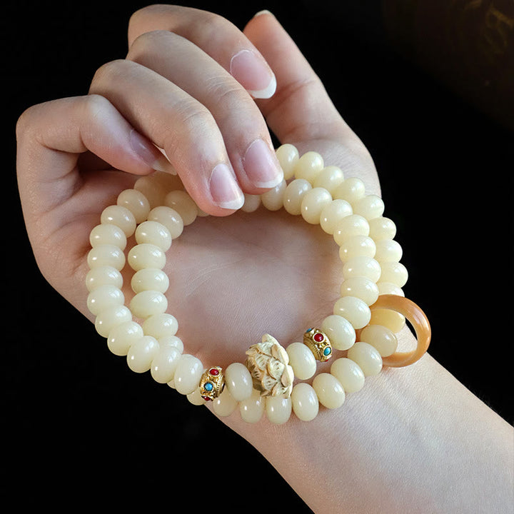 Braccialetto doppio giro Buddha Stones Bodhi Seed Peach Wood Lotus Wealth