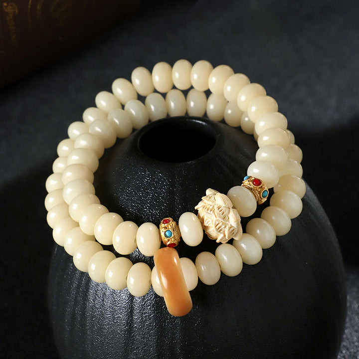 Braccialetto doppio giro Buddha Stones Bodhi Seed Peach Wood Lotus Wealth