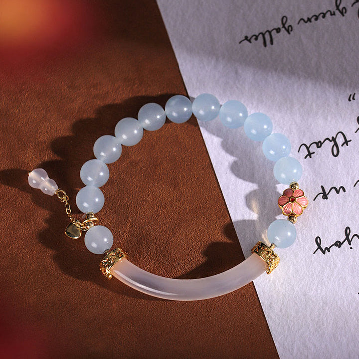 Braccialetto a metà polsino in perle di calcedonio blu e cristallo rosa Buddha Stones
