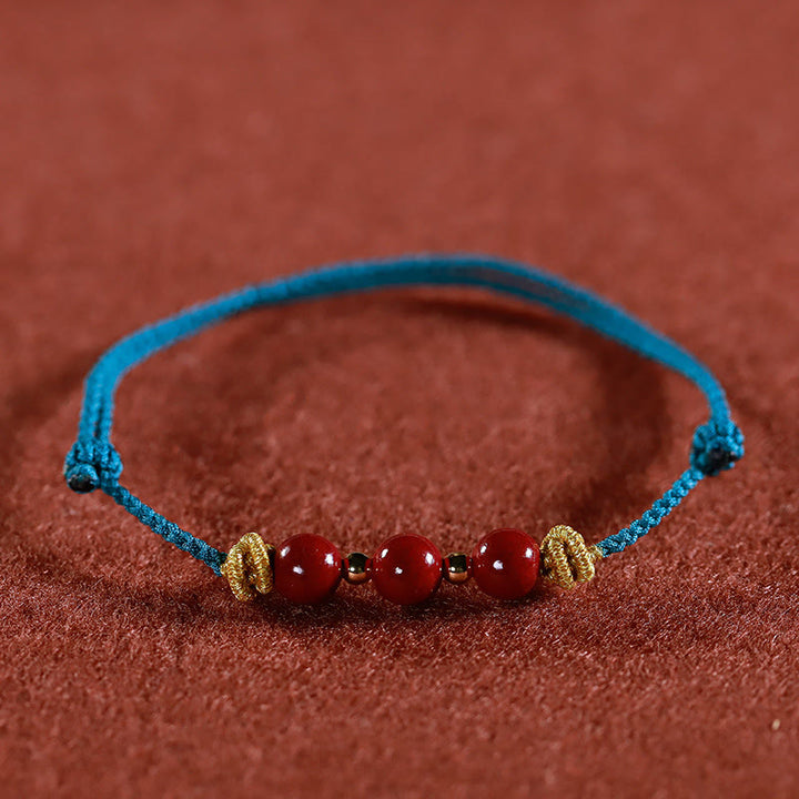 Braccialetto Buddha Stones con corda colorata e cinabro calmo