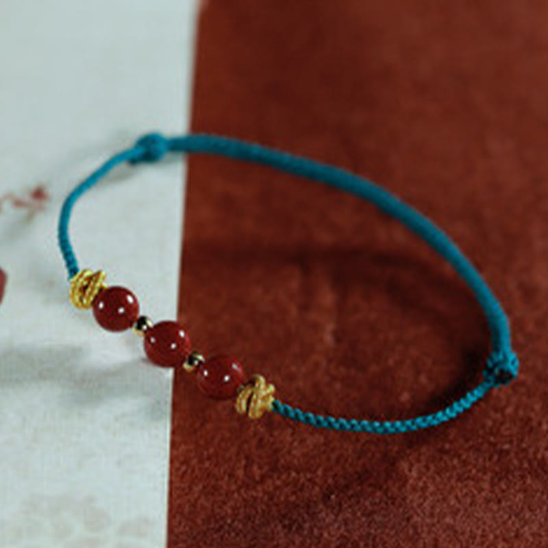 Braccialetto Buddha Stones con corda colorata e cinabro calmo