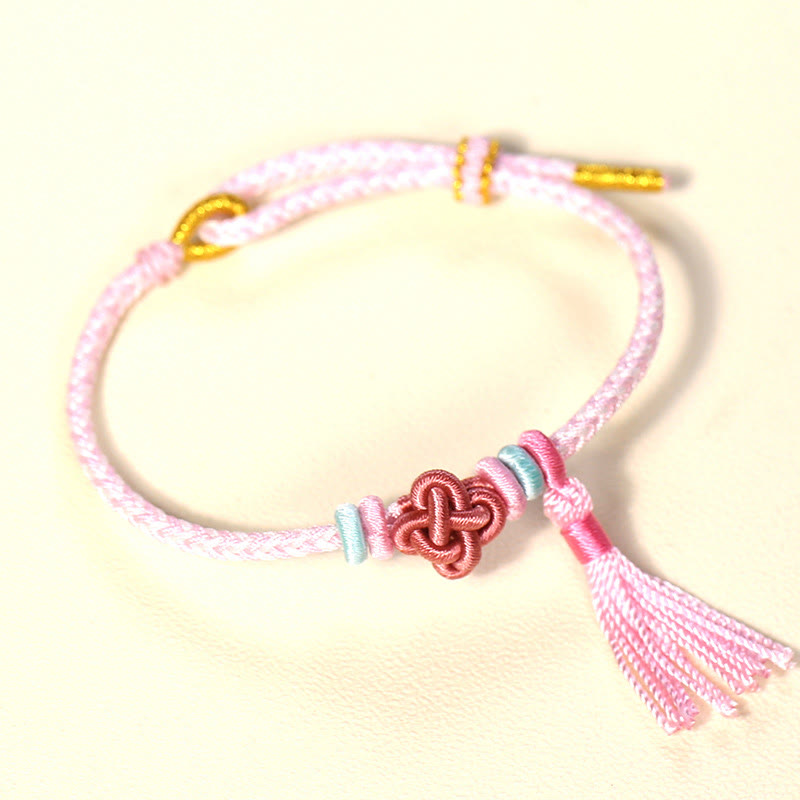 Braccialetto di protezione con nappe con nodo in fiore di pesco e Buddha Stones colorate