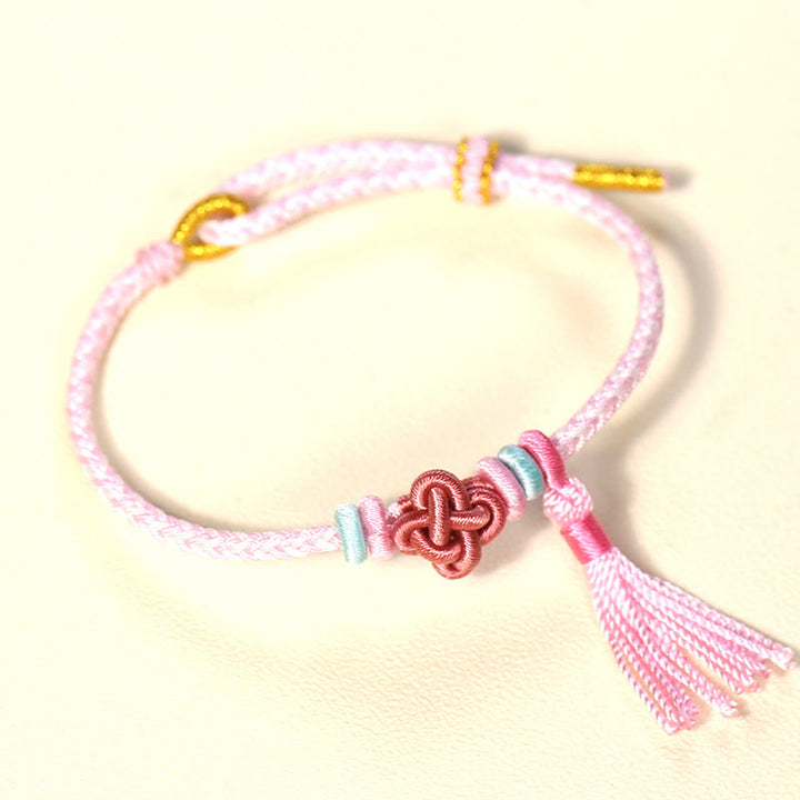 Braccialetto di protezione con nappe con nodo in fiore di pesco e Buddha Stones colorate