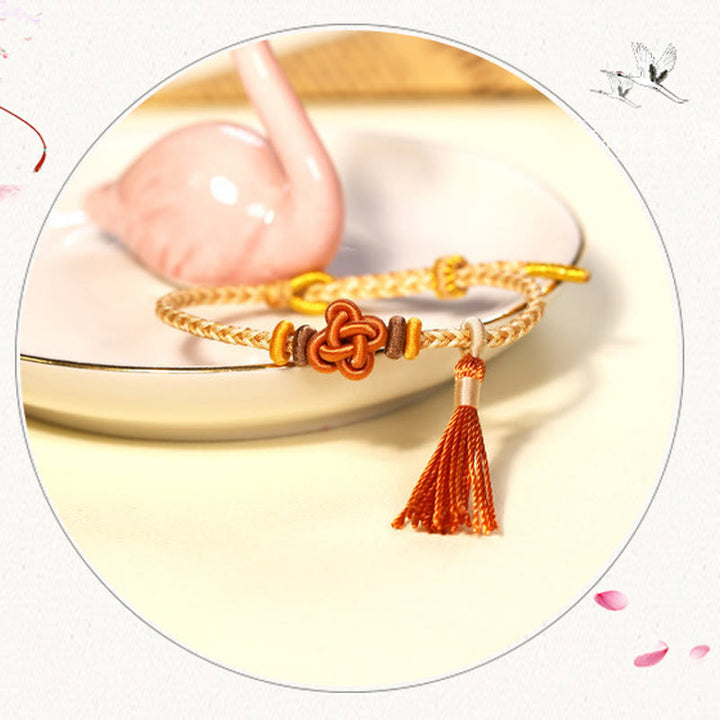 Braccialetto di protezione con nappe con nodo in fiore di pesco e Buddha Stones colorate