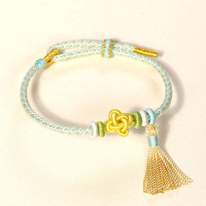 Braccialetto di protezione con nappe con nodo in fiore di pesco e Buddha Stones colorate