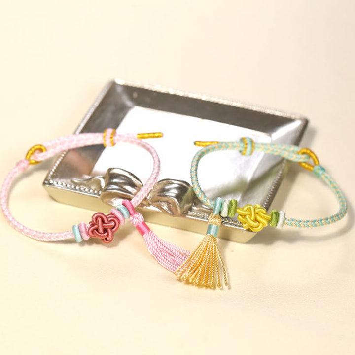 Braccialetto di protezione con nappe con nodo in fiore di pesco e Buddha Stones colorate