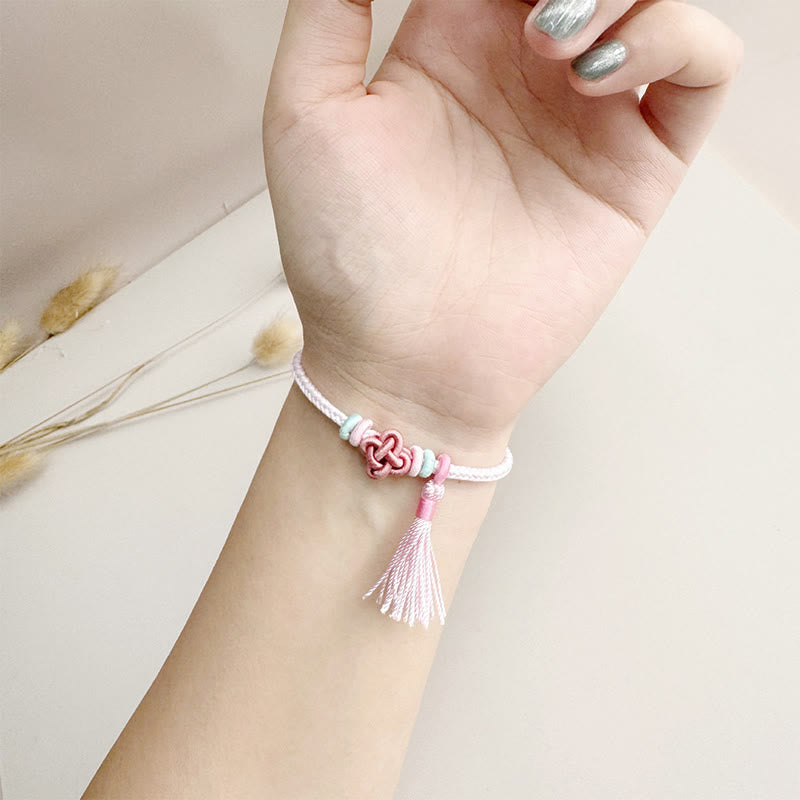 Braccialetto di protezione con nappe con nodo in fiore di pesco e Buddha Stones colorate