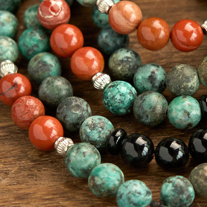 Buddha Stones 108 Mala Onice nero naturale Diaspro rosso Perline turchesi Braccialetto di protezione con nappa a testa di Buddha