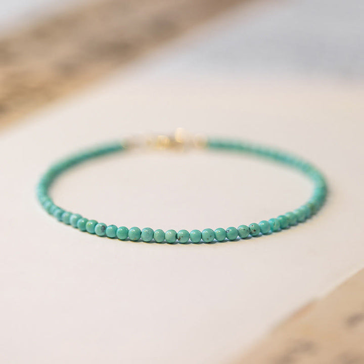 Braccialetto della saggezza in rame placcato oro 14k con perline ultrasottili color turchese da 2 mm Buddha Stones