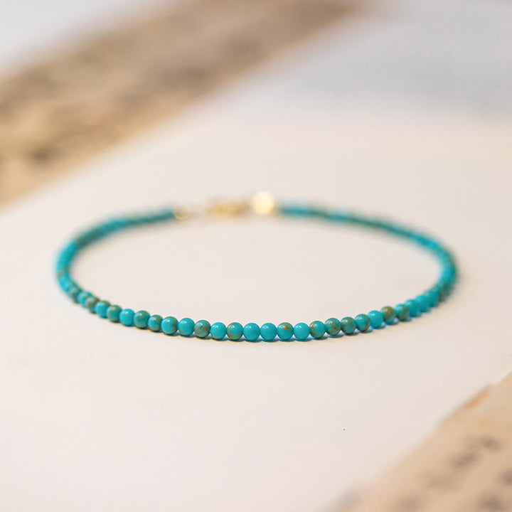 Braccialetto della saggezza in rame placcato oro 14k con perline ultrasottili color turchese da 2 mm Buddha Stones