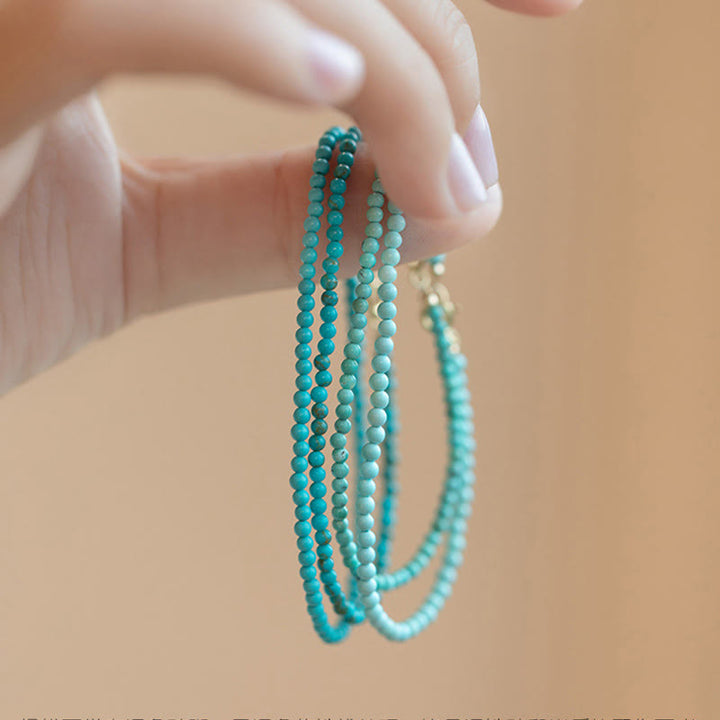 Braccialetto della saggezza in rame placcato oro 14k con perline ultrasottili color turchese da 2 mm Buddha Stones